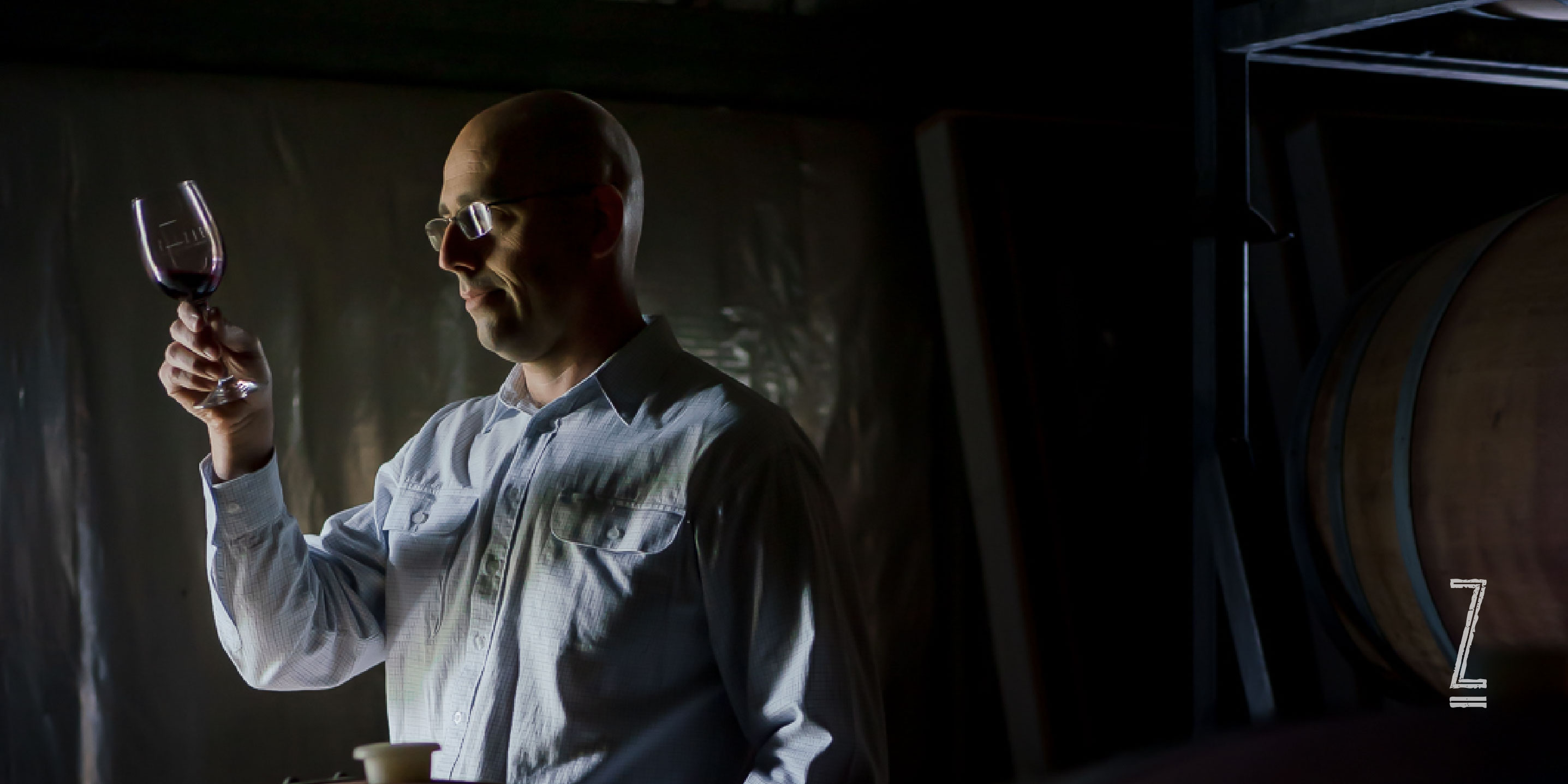 Winemaker looking at wine in glass